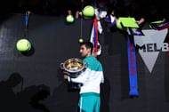 Novak Djokovic signs autographs for his fans after winning the Australian Open